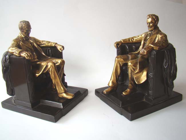 A pair of 'Lincoln in the chair' bookends by Philadelphia Manufacturing Co., circa 1935
